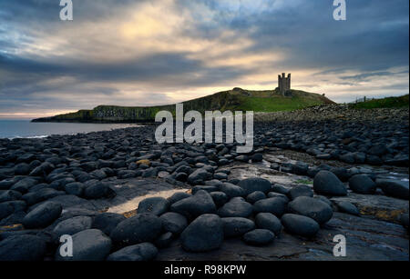 Dunstanburgh Castle at Dawn, Northumberland, England Stock Photo