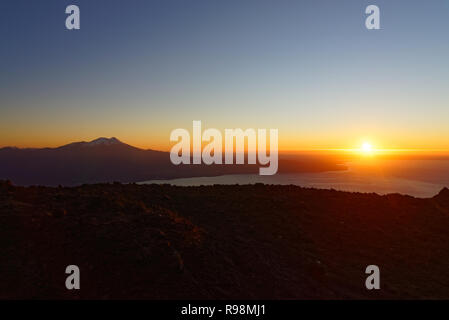 Aerial view with drone from the ski center in the volcano Osorno, Puerto Varas. With Lake Llanquihue and the Calbuco Volcano at sunset Stock Photo