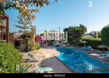 CRETE, GREECE - AUGUST 2018: Swimming pool with clean water and sunbeds around it. Stock Photo