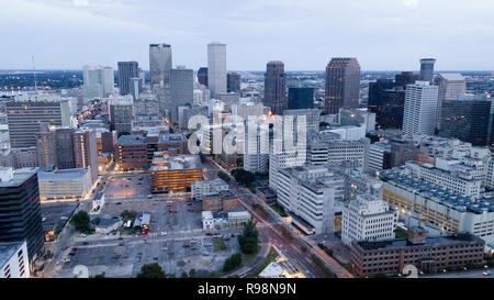 The daylight fades as lights inside buildings turn on in an aerial view of New Orleans Stock Photo