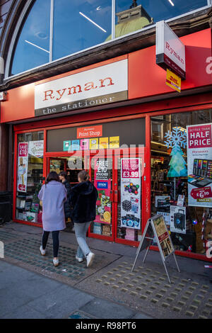 couple walking towards the exterior of the Ryman Stationery Shop on Tottenham Court Rd, Bloomsbury, London W1, England Stock Photo