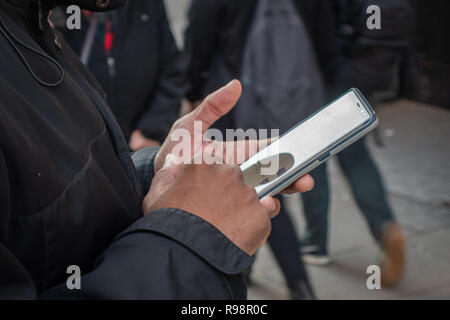 Closeup of mans fingers using a Mobile Phone Stock Photo