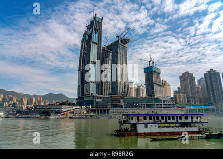 CHONGQING, CHINA - SEPTEMBER 19: View of city buildings and boats along the waterfront of Chaotianmen dock on September 19, 2018 in Chongqing Stock Photo