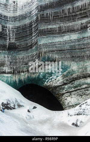 Icicles at entrance to an ice cave in a lobe of Mýrdalsjökull Glacier, which sits atop Katla Volcano, in winter in Iceland Stock Photo