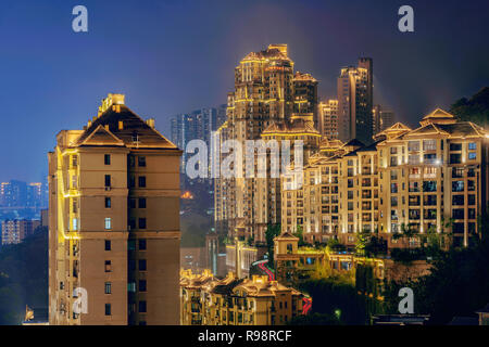 CHONGQING, CHINA - SEPTEMBER 22: Hillside luxury apartment buildings at night on Nanbin road in the downtown area on September 22, 2018 in Chongqing Stock Photo
