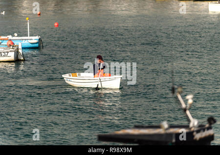 Fisherman coming ashore from his boat after a days fishing in St.ives bay St.ives Cornwall UK Europe Stock Photo