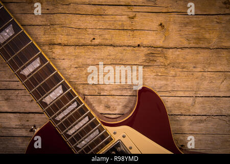 Close-up of electric guitar lying on vintage wood background, with copy space Stock Photo