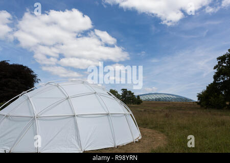 Dome of the Great Glasshouse at the National Botanic Garden of Wales with a small dome tent in foreground Stock Photo