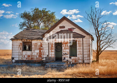 An old farmhouse is falling into disrepair amid the wheat fields of Eastern Washington. Stock Photo