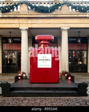 A giant replica of a red, Christmas-styled Chanel No 5 perfume