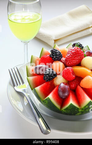Fancy cut melon with assorted fruit inside and juice to drink Stock Photo