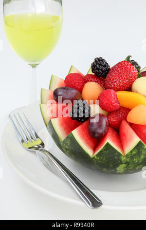 Fancy cut melon with assorted fruit inside and juice to drink Stock Photo