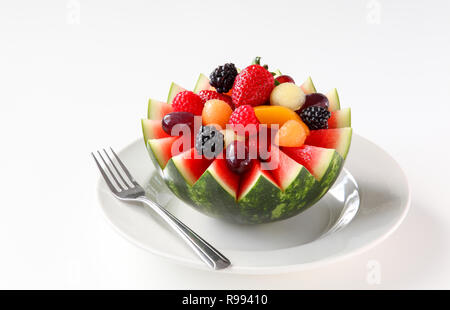 Fancy cut watermelon with assorted fruit inside and juice to drink Stock Photo