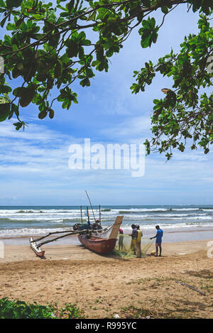 Fishermen and traditional fishing boats in Weligama, Sri Lanka Stock Photo