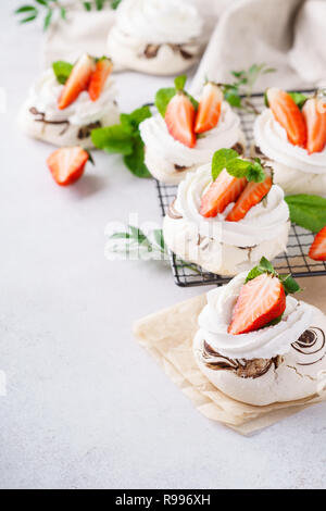 Pavlova cakes with cream and fresh summer berries Stock Photo