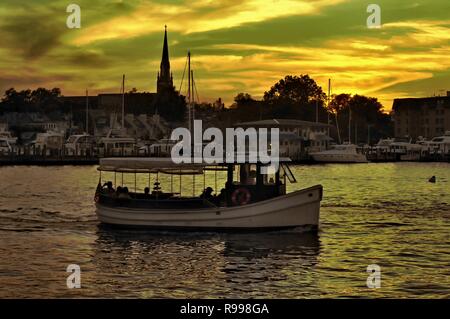 Annapolis Water Taxi traveling during the summer dusk on the Severn River. Stock Photo