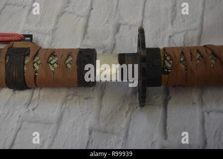 Beautiful decorative Japanese katana for aikido, sporting weapons, not sharp katana with a beautiful brown color and hand. Stock Photo