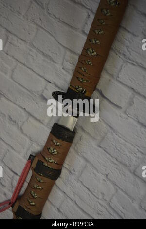 Beautiful decorative Japanese katana for aikido, sporting weapons, not sharp katana with a beautiful brown color and hand. Stock Photo