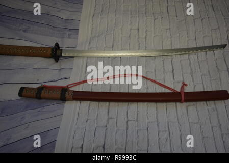 Beautiful decorative Japanese katana for aikido, sporting weapons, not sharp katana with a beautiful brown color and hand. Stock Photo