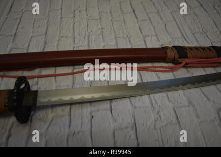Beautiful decorative Japanese katana for aikido, sporting weapons, not sharp katana with a beautiful brown color and hand. Stock Photo