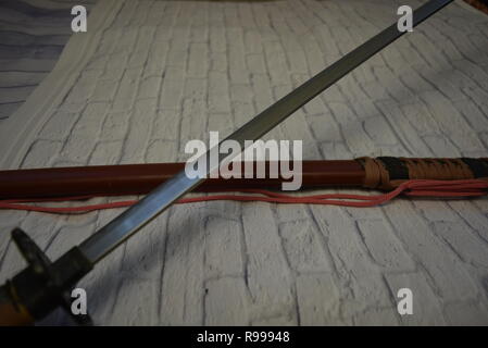 Beautiful decorative Japanese katana for aikido, sporting weapons, not sharp katana with a beautiful brown color and hand. Stock Photo