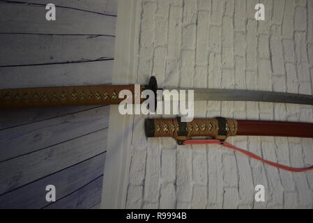 Beautiful decorative Japanese katana for aikido, sporting weapons, not sharp katana with a beautiful brown color and hand. Stock Photo