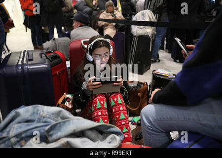 Passengers at Gatwick airport waiting for their flights following the delays and cancellations brought on by drone sightings near the airfield. Stock Photo