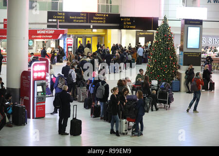 Passengers at Gatwick airport waiting for their flights following the delays and cancellations brought on by drone sightings near the airfield. Stock Photo