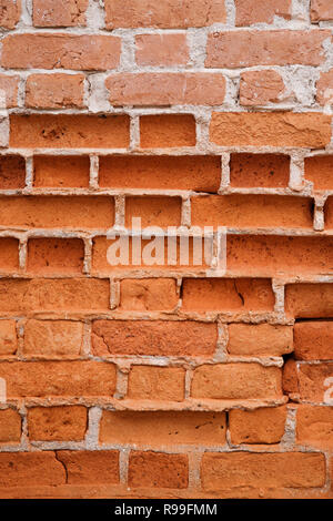 background image of old eroded brick wall with some bricks partly gone Stock Photo