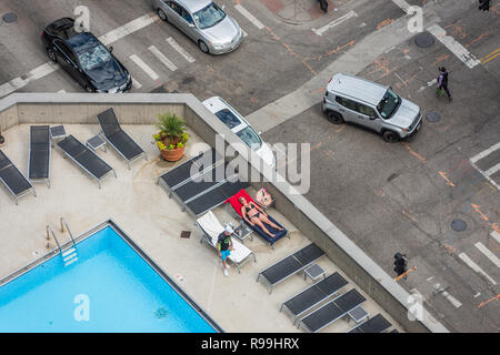 Aerial view of woman sunbathing by the pool Stock Photo - Alamy