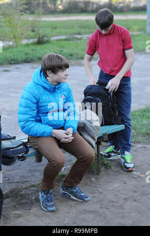 Kovrov, Russia. 6 October 2013. Teens on a bench after engaged in discipline gimbarr in the schoolyard Stock Photo