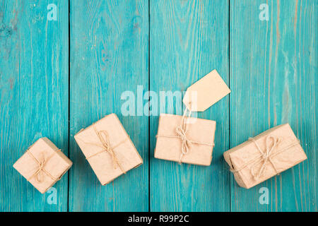 Gift boxes and tag on blue wooden table Stock Photo