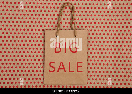 Handmade shopping bag wint inscription "BIG SALE" on craft paper background in red polka dots Stock Photo