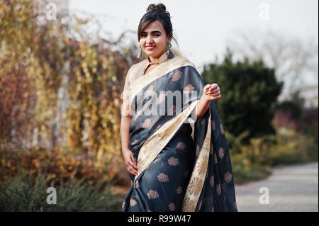 Elegant brunette south asian indian girl in saree standing under arch and  show namaste hands sign Stock Photo - Alamy