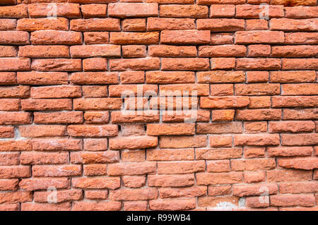 detail of distressed, weathered and spalling red brick wall Stock Photo