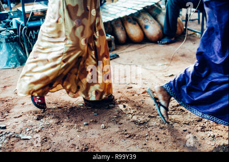 Women dancing in the mud. Multi Ethnic music party to celebrate western and developing countries cooperation. Bamako, Mali. Africa Stock Photo