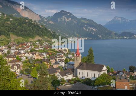 Parish Church St. Maria and the village of Weggis along the shore of Lake Lucerne, Switzerland. Stock Photo