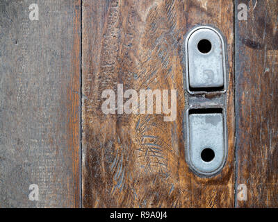 Old vintage steel lock of garage roll door on wooden floor with copy space. Stock Photo