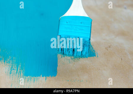 Close view of a turquoise painted surface showing dark vertical streaks ...