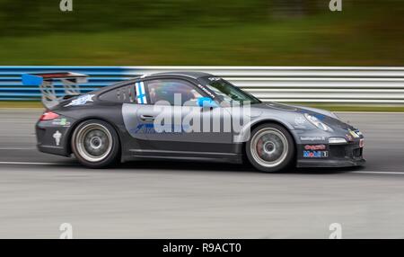 HÄMEENLINNA, FINLAND – APRIL 25 2016: A sportscar at high speed on racetrack at Ahvenisto Race Circuit in Finland. Stock Photo