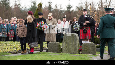 Lockerbie, Scotland, UK. 21st December, 2018. Victoria Cummock (with wreath) and relatives whos husband John died on the Pan Am flight 103. ockerbie Bombing 30th anniversary wreath laying in the Garden of Remembrance at Dryfesdale Cemetery, Lockerbie, Scotland, UK Credit: Allan Devlin/Alamy Live News Stock Photo
