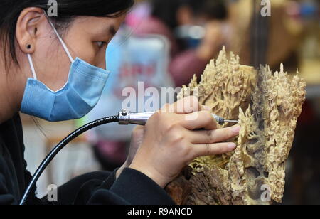 Putian, China's Fujian Province. 20th Dec, 2018. A worker carves a piece of artware at a workshop in Putian, southeast China's Fujian Province, Dec. 20, 2018. Putian currently has 46,748 private enterprises, accounting for 92 percent of the city's enterprises, creating more than 50 percent of the tax revenue and providing more than 80 percent of jobs. Credit: Zhang Guojun/Xinhua/Alamy Live News Stock Photo