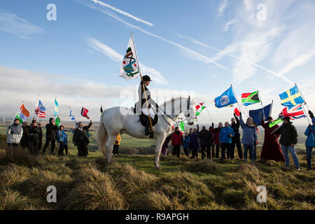 Lockerbie, Scotland, UK. 22nd December, 2018. A Walk for Peace up Burnswark near Lockerbie in memory of those who died in the Lockerbie Disaster. The walk follows the age-old tradition in Scotland of taking to the hills to find peace and contemplate the future. The walk up Burnswark with the flags of the 21 nations that the victims from the Pan Am flight 103 came from was organises by representatives from Allanton World Peace Sanctuary and local artists Credit: Allan Devlin/Alamy Live News Stock Photo