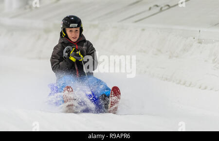 Bispingen, Germany. 22nd Dec, 2018. Benny goes down the piste with a sleigh in the Snow Dome. Credit: Philipp Schulze/dpa/Alamy Live News Stock Photo