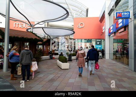 The Malls shopping centre in Basingstoke, Hampshire, UK. Christmas shoppers on Saturday morning in the recently refurbished shopping area. Stock Photo