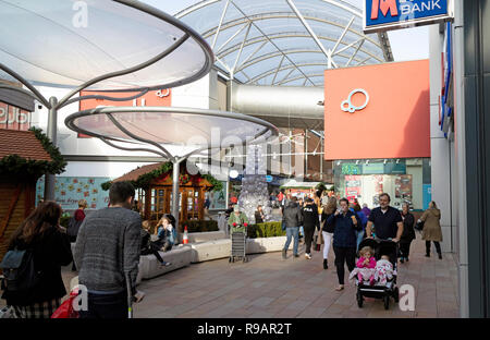 The Malls shopping centre in Basingstoke, Hampshire, UK. Christmas shoppers on Saturday morning in the recently refurbished shopping area. Stock Photo