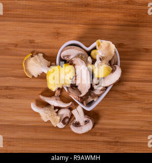 Variety of mixed exotic mushrooms on a cutting board. Stock Photo