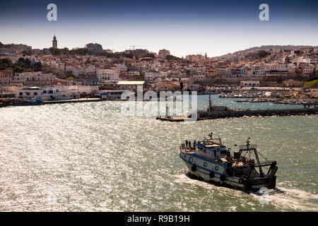 Morocco, Tangier, Port, fishing boat entering, inner harbour beside Kasbah Stock Photo