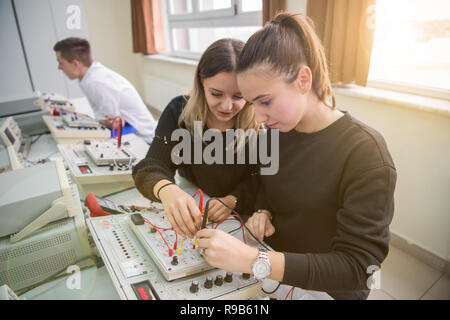 Group of young students doing technical vocational practice with teacher in the electronic classroom, Education and technology concept Stock Photo