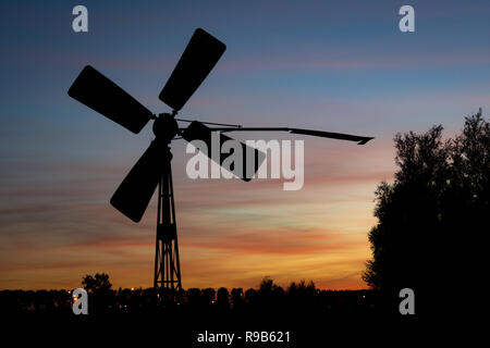 Old pumping windmill in the dutch countryside near Gouda, Holland. These mills pump up the water to a higher elevation to keep the land dry. Stock Photo